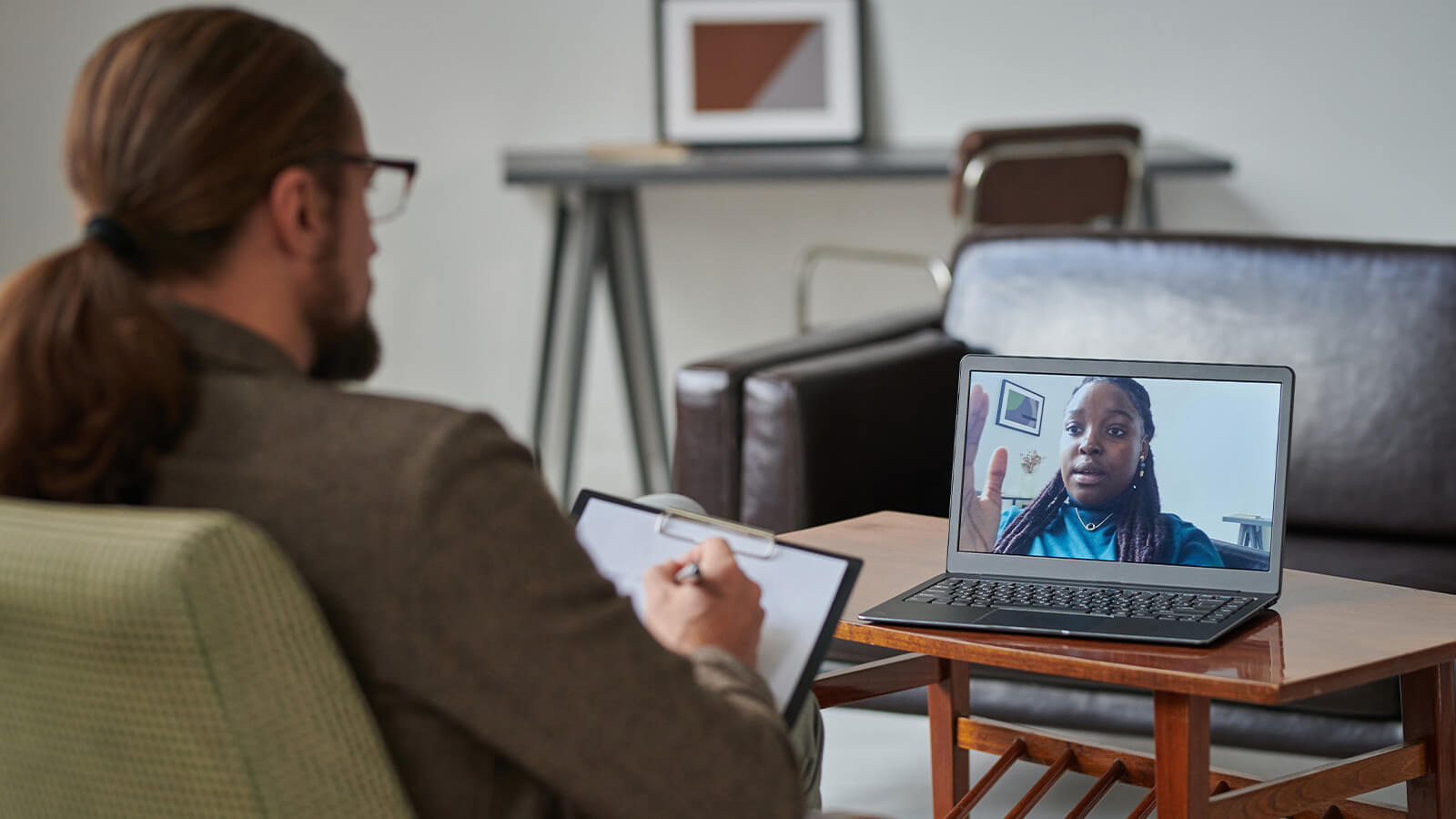 professional psychologist making notes on paper